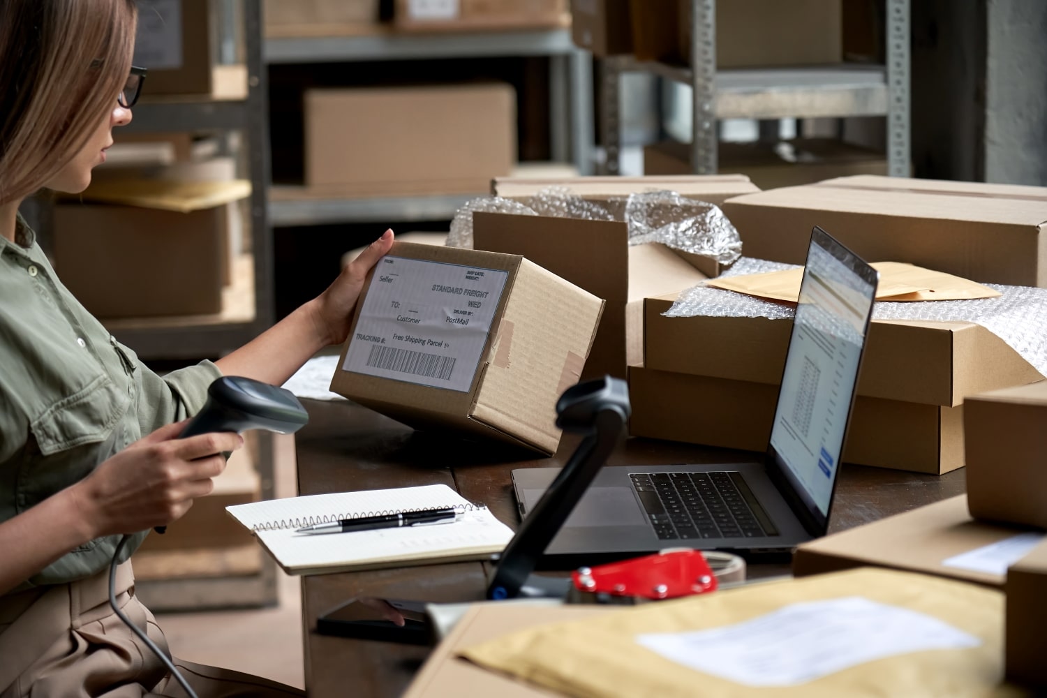 female-seller-scanning-ecommerce-shipping-box-in-d-2021-09-02-07-22-46-utc-min.jpg